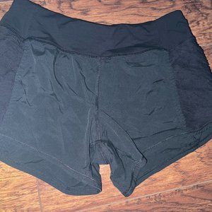Lululemon Black 4" shorts with side ruching detail and zip pockets size 4